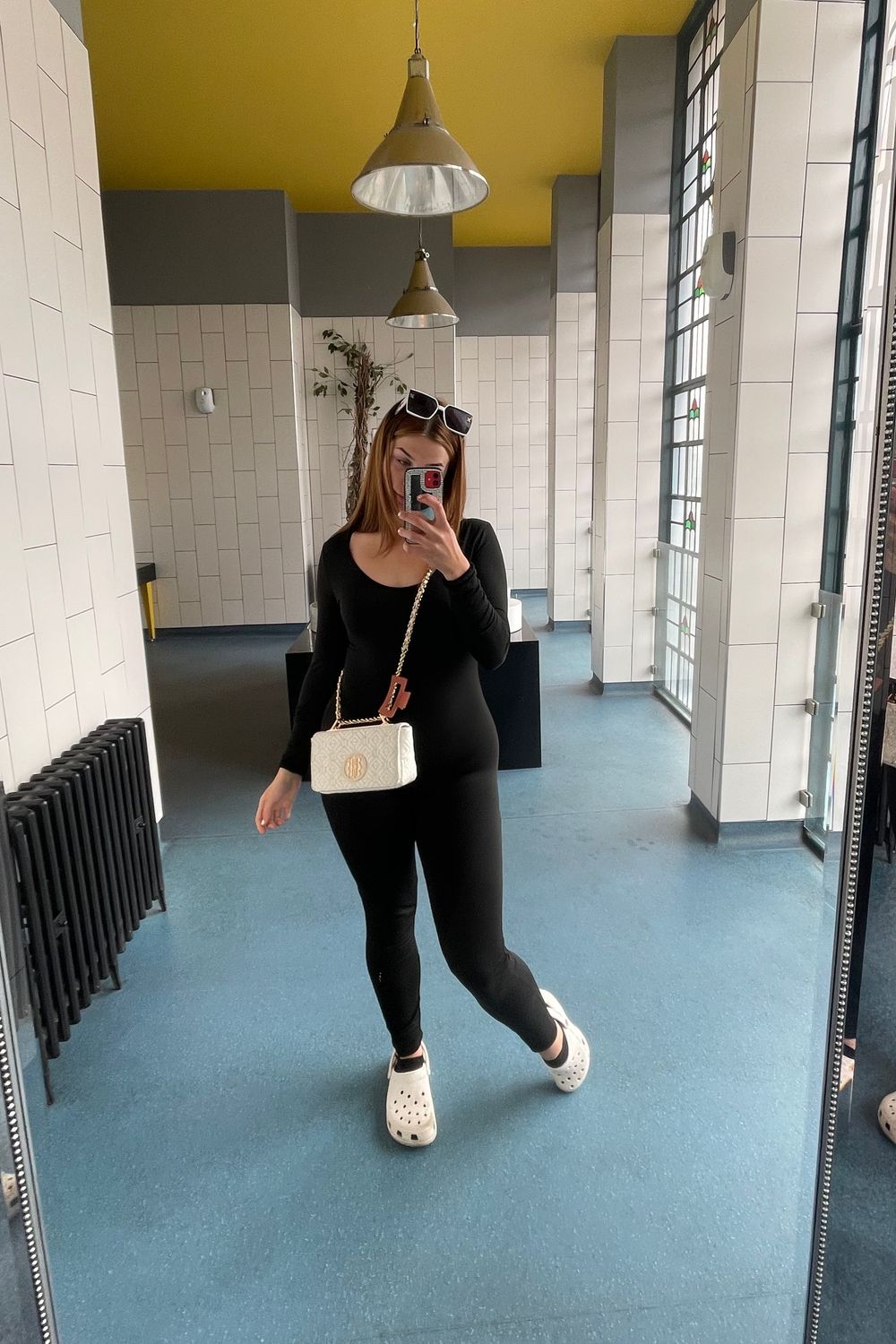 Post featuring White RI monogram padlock cross body bag