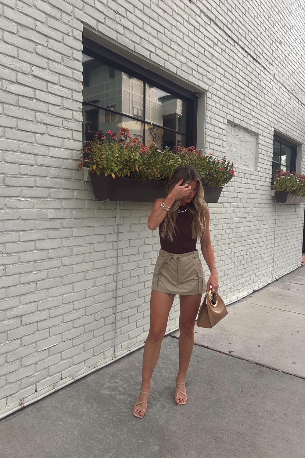 Post featuring Amiya Leaf Handle Sculpture Bag - Brown